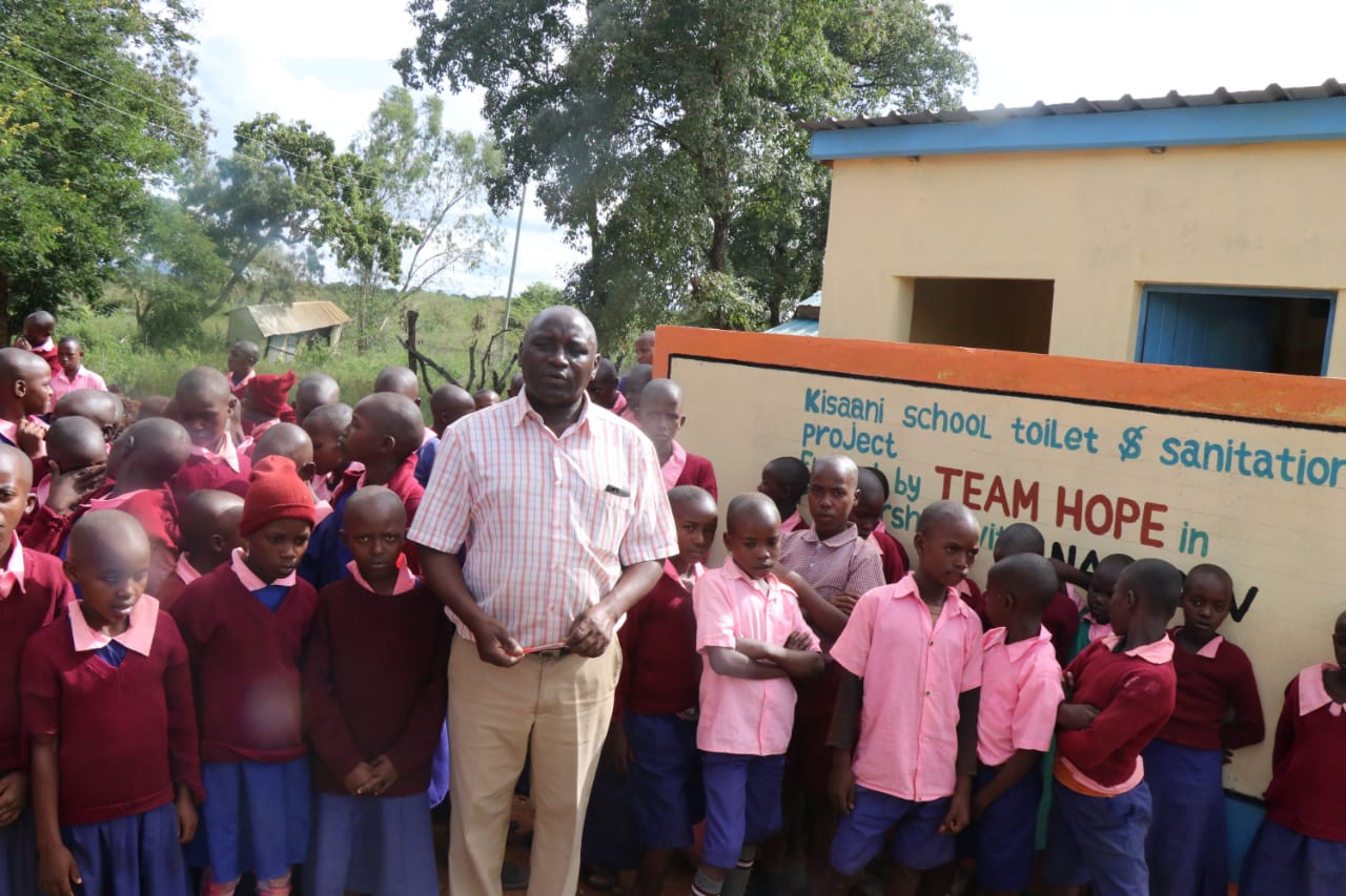 Teachers and students infront of new toilet block