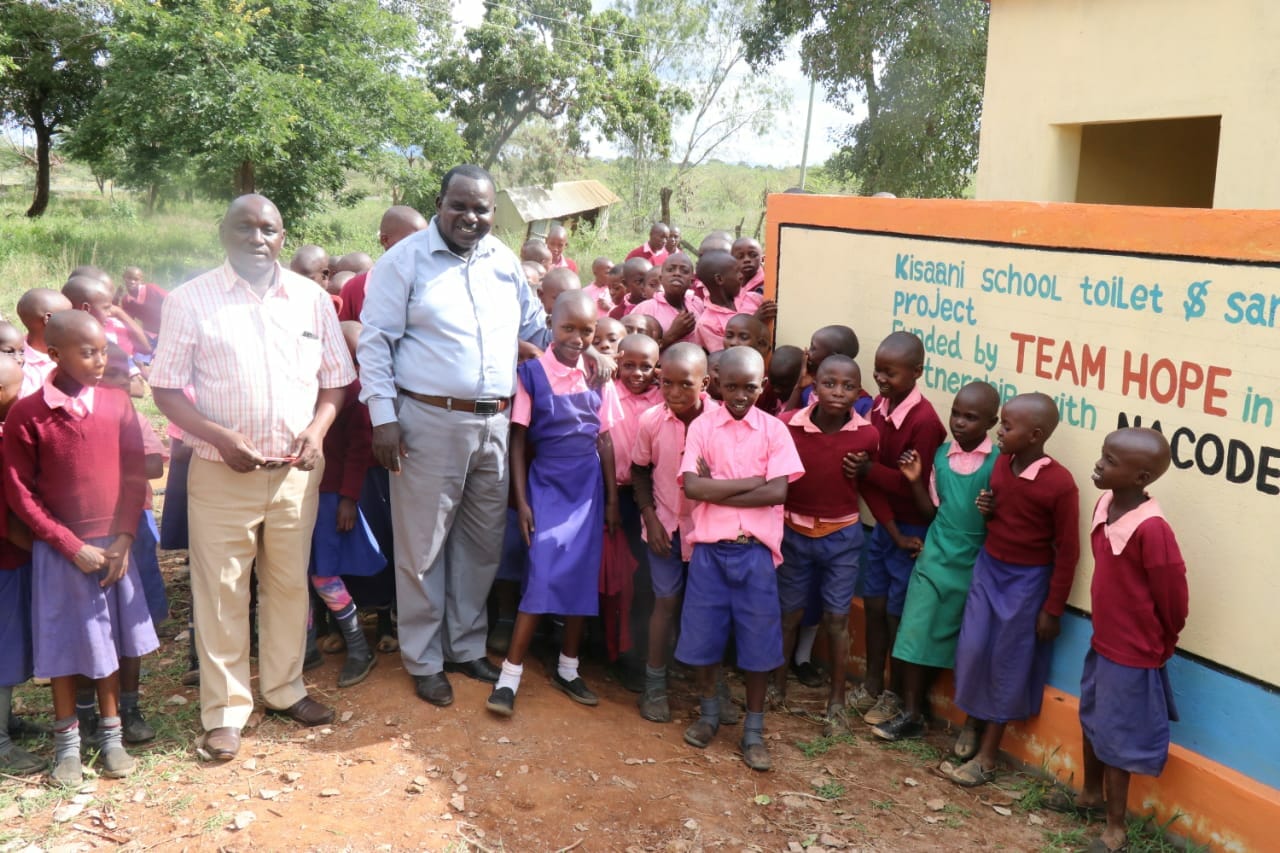 Teachers and students infront of new toilet block